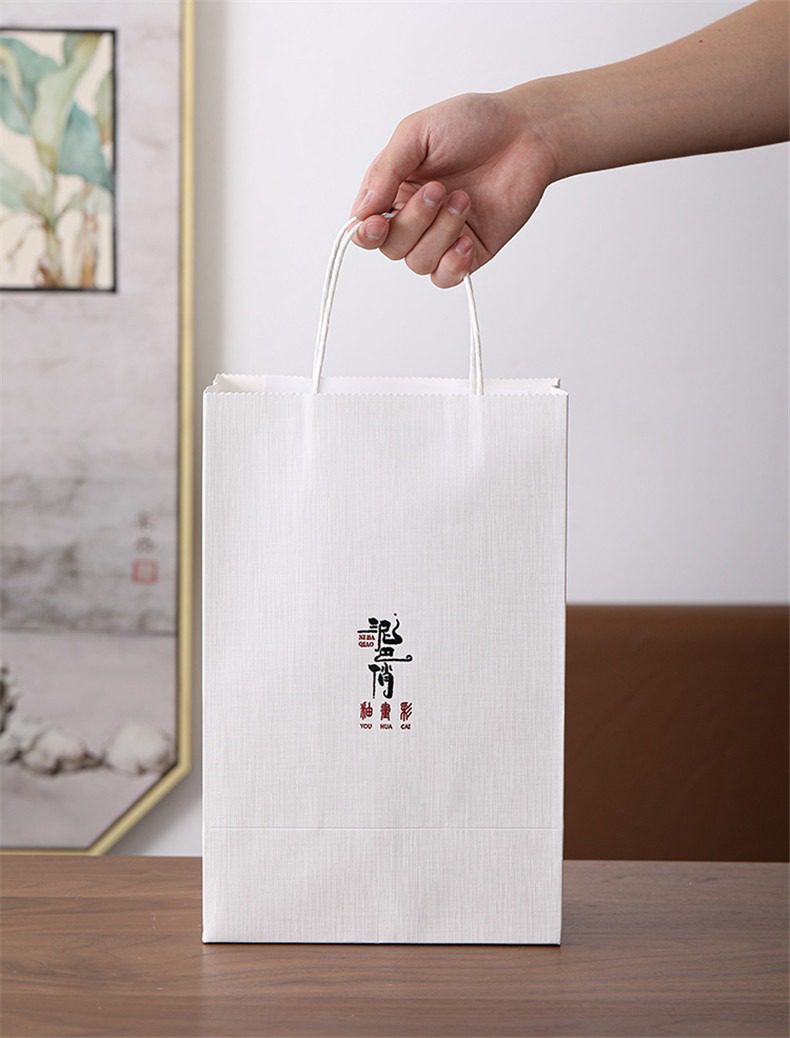 黑陶行雲提樑壺乾泡茶盤茶具組，南山居精緻品牌提袋，白色紙質紋理細膩，簡約禪意設計，適合精品茶具禮盒包裝。