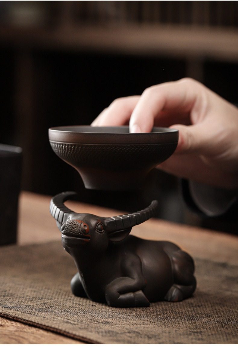 黑陶清溪過濾茶漏，南山居黑泥手工紫砂茶杯，配以栩栩如生的牛造型茶杯托，細膩質感展現東方禪意美學。