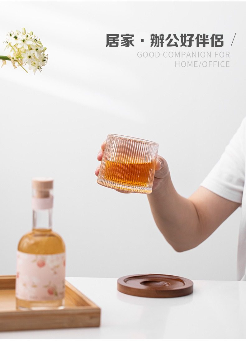 日式玻璃水杯，南山居時尚條紋玻璃茶杯，盛裝琥珀色茶湯，搭配圓形木質茶托與雅緻茶葉瓶，現代茶具。