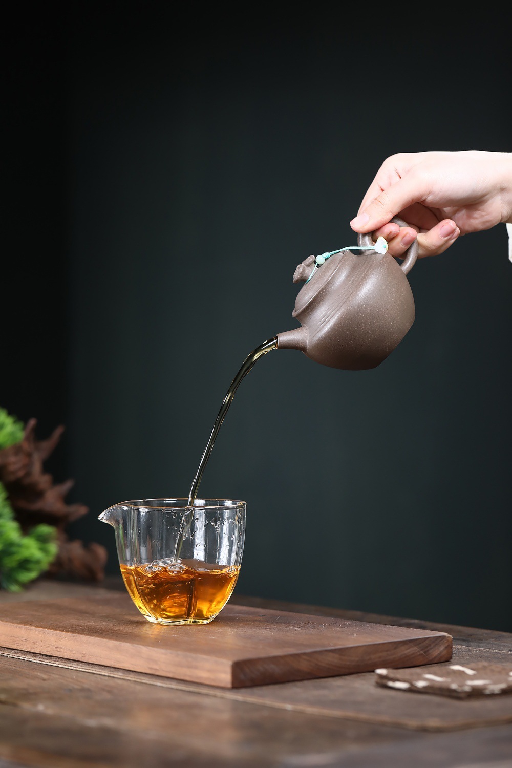宜興紫砂壺原礦青灰段泥歸樸靈芝壺(230ml)，南山居手工紫砂壺倒茶畫面，壺身質樸優雅，出水如注，注入剔透玻璃茶海中，展現流暢茶道儀式感。
